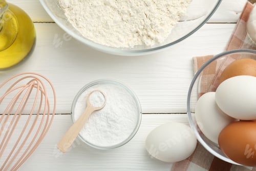 Preview: Flat lay composition with baking powder and eggs on white wooden table