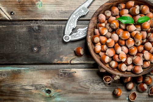 Preview: Hazelnuts in a bowl with a Nutcracker.