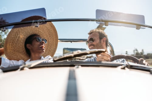 Preview: Multiracial couple in a convertible vintage car