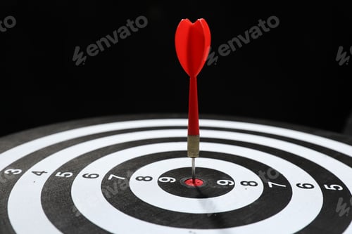 Preview: Targeting. Dart board with arrow on black background, closeup
