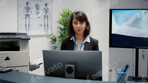 Preview: Portrait of hospital reception desk employee working on medical service