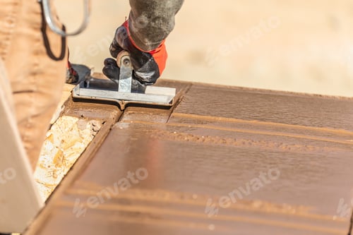 Preview: Construction Worker Using Hand Groover On Wet Cement Forming Coping Around New Pool