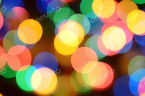 Preview: Blurred festive colorful lights over black useful as background. All main colors included