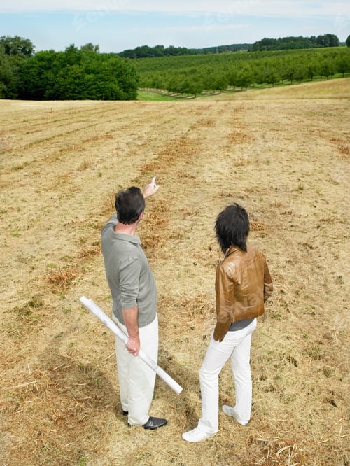 Preview: Architects discussing in a field