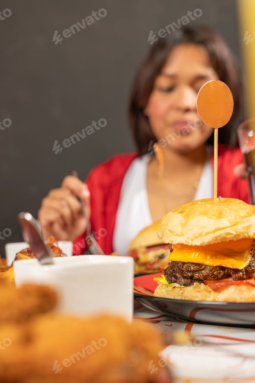Preview: Friends enjoying fast food meal with hamburgers and fried chicken