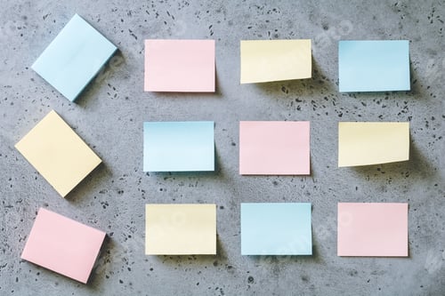 Preview: Colorful empty sticky notes on a grey textured background. The concept organization and planning.