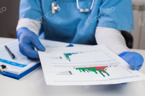 Preview: Doctor wearing protective gloves holding document chart