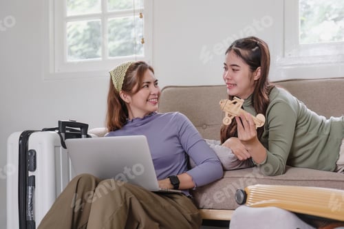 Preview: Two Asian female friends plan a vacation, pack their suitcases before going on vacation.