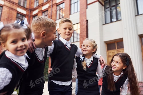 Preview: Group of kids in school uniform that is outdoors together near education building