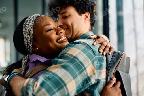 Preview: Happy multiracial couple embracing at the university.