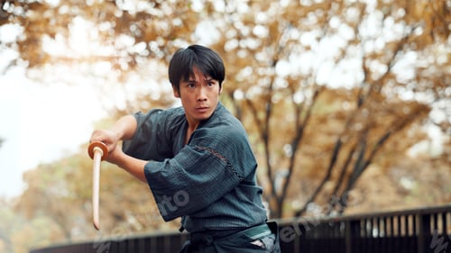 Preview: Martial arts, serious man and wood sword outdoor with fight, battle and samurai training on road. P