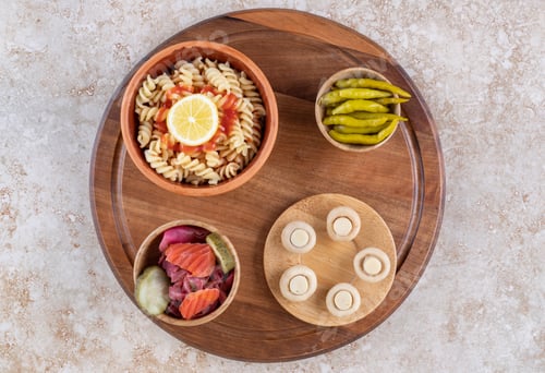 Preview: A wooden board of tasty pasta with mushrooms and spices