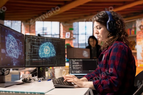 Preview: AI industry startup technician coding and listening music in office