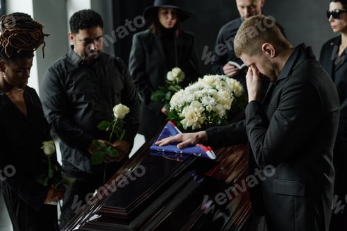 Preview: Group of Diverse Adults Mourning at Funeral and Grieving Beside Coffin