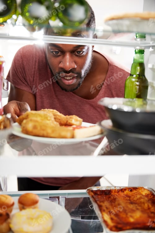 Preview: View Looking Out From Inside Of Refrigerator Filled With Unhealthy Takeaway Food As Man Opens Door