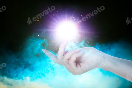 Preview: Woman creating bright light in smoke against black background, closeup. Aura, spiritual practice