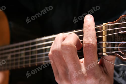 Preview: Closeup shot of a male's hand playing the guitar