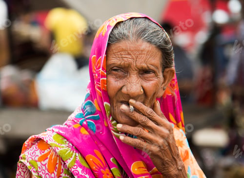 Preview: Old age woman smoking Indian handmade cigarette.