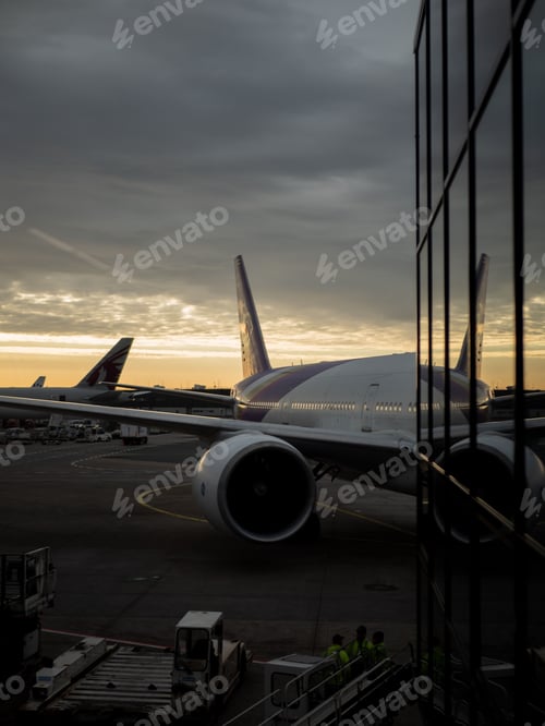 Preview: Vertical shot of airplane parked in Frankfurt airport during sunset