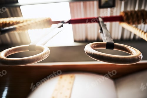 Preview: Where muscles are made. Shot of gymnastic rings in a gym with no people.