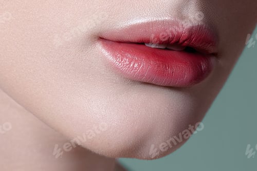 Preview: Lips of young sensual woman with clear glowing skin closeup