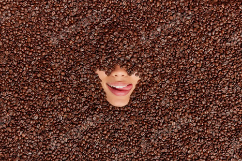 Preview: Unrecognizable woman fully covered with roasted brown coffee beans shows only nose and mouth sticks