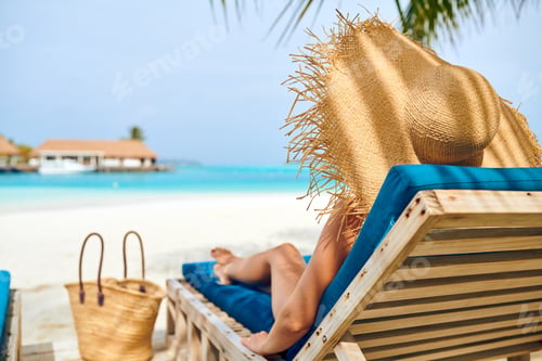 Preview: Young Woman At Beach On Wooden Sun Bed Loungers. Summer Vacation At Maldives.