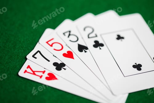 Preview: poker hand of playing cards on green casino cloth