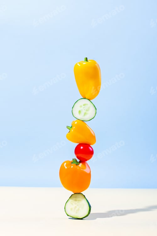 Preview: Creative food balance, vegetables equilibrium shot on blue background.