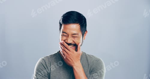 Preview: Asian man, crazy and laughing in studio for funny joke, lol and smile for comedy. Face, excited and
