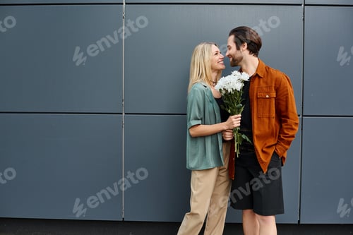 Preview: Romantic duo amidst blossoms, handsome man and attractive woman