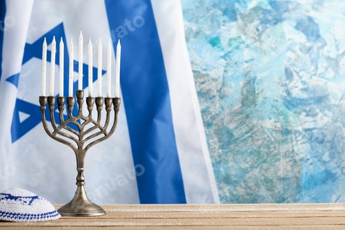 Preview: Happy Hanukkah. Hanukkah old Menorah against background of the Israeli flag with sunlight or bokeh o