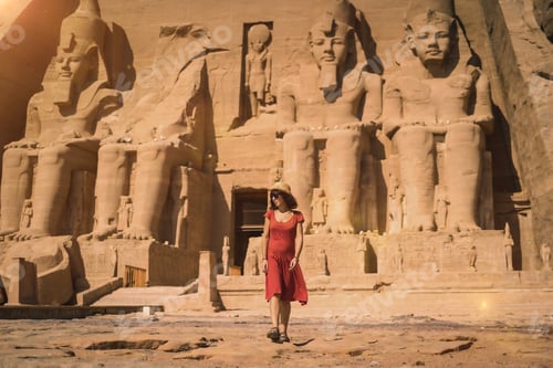 Preview: A young tourist in a red dress entering the Abu Simbel Temple in southern Egypt