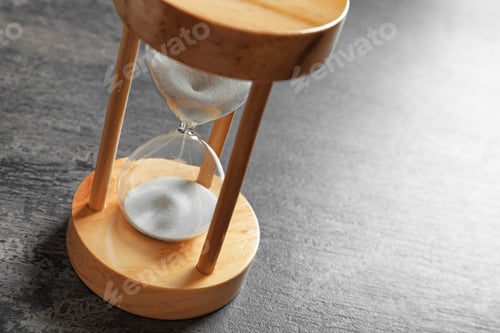 Preview: Hourglass with flowing sand on table. Time management