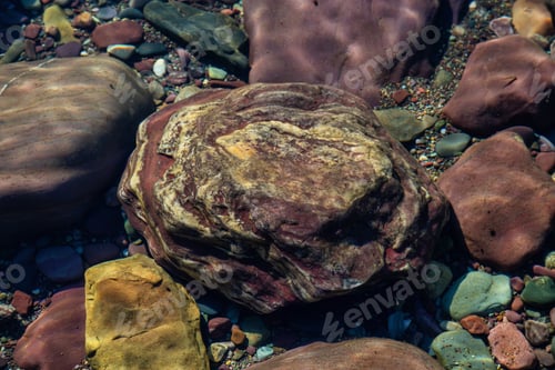Preview: Colorful Rocks in a Glacier Lake during a sunny summer day