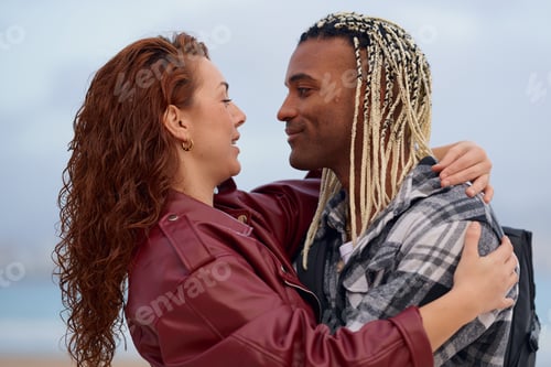 Preview: Couple joyfully sharing a moment on the beach during sunset