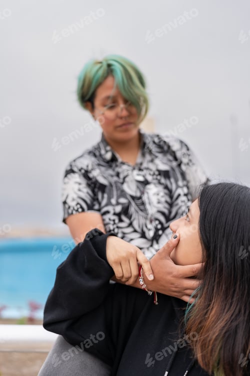 Preview: Lesbian woman caressing her partner's face