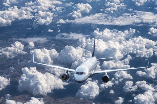 Preview: Airplane is flying above the clouds at sunset in summer