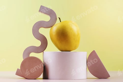 Preview: Composition of a yellow apple of a platform with different wooden shapes surrounding it