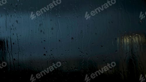 Preview: Water drops on window trickling down on late evening city background. Concept. Heavy cloudy sky and