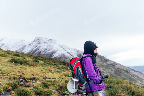 Preview: well-equipped mountaineer with a red backpack
