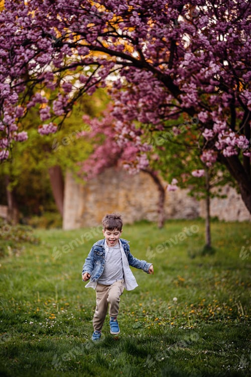 Preview: Happy Boy Running Through Blossoming Spring Garden