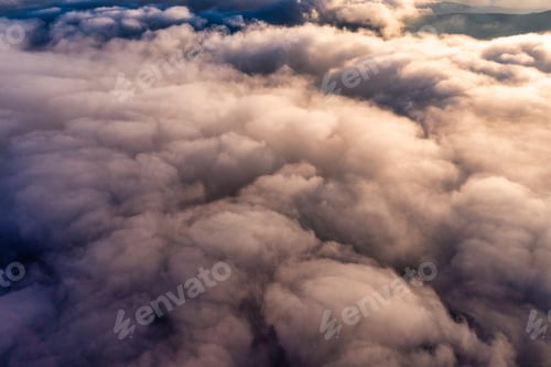 Preview: Thick layer of white clouds above mountains at sunrise