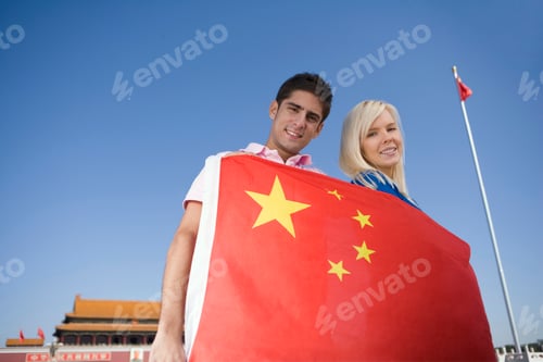 Preview: Young couple holding a flag in front of Tiananmen Gate, Beijing, China