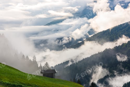Preview: Small alpine house in green forest mountains