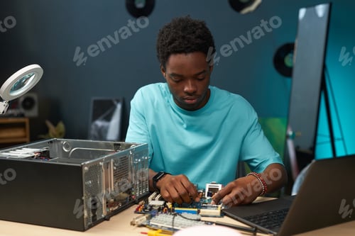 Preview: Young Repairman Fixing Computer Components