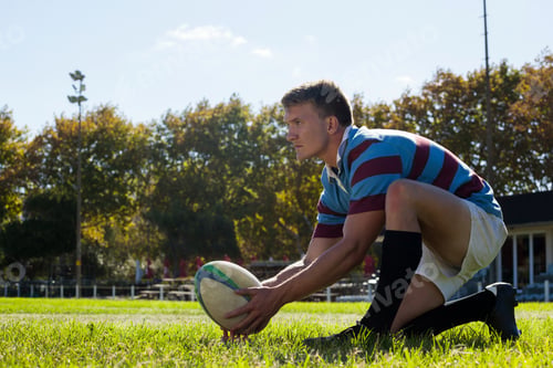 Preview: Side view of man getting ready to kick for goal