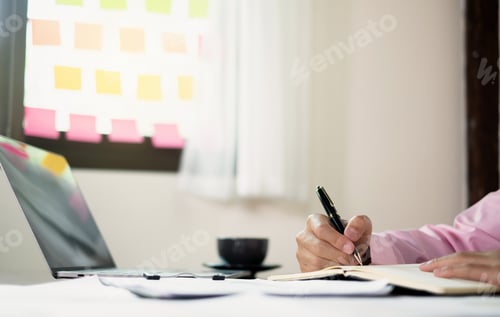 Preview: The businessman hand sits at their desks and calculates financial graphs showing the results