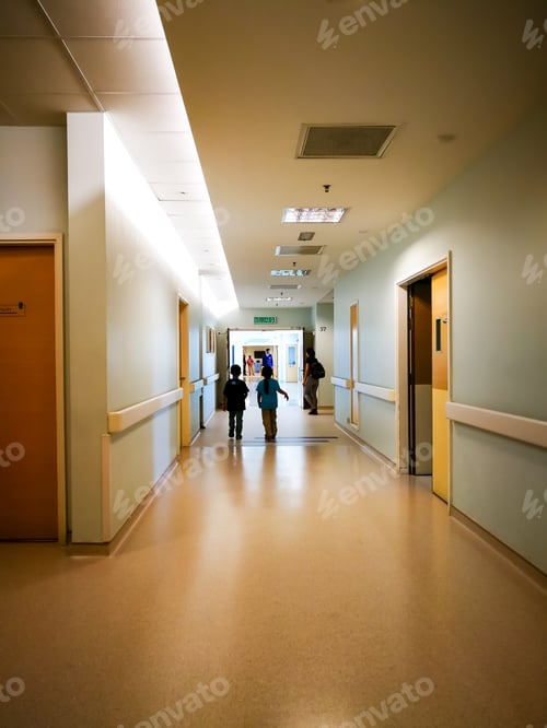 Preview: hospital corridor with two children silhouettes walking. view from behind