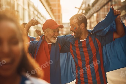 Preview: Happy sports fan and his senior father celebrating victory of their favorite team during world cup.